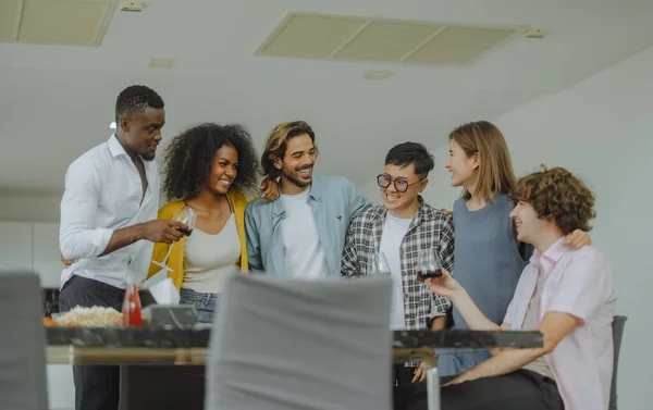 stock image Vibrant multicultural reunion of friends, filled with laughter, diverse stories, exciting interaction. A blend of togetherness, bonding, celebration, where music, dance, chat create joyful atmosphere