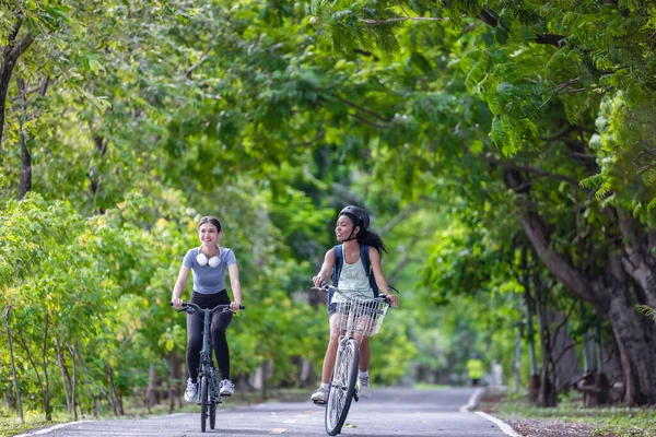 Female cyclist combine eco-consciousness with active lifestyle, using bikes for workout and travel, a portable solar panel for device charging, and embracing recycling practices for circular economy.