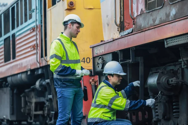 stock image Locomotive engineering technicians maintain emission control on train railways, identifying oil and fuel leaks and inspecting, testing, and repairing malfunctioning engines for optimal efficiency.