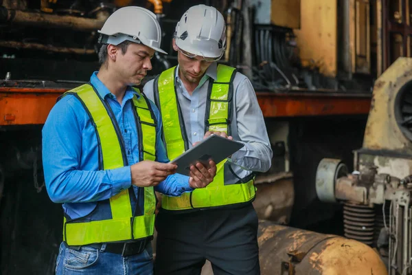 Software engineers collaborate, discuss ways to enhance a smart energy analytics app for locomotive operation. Real-time monitoring optimizes data usage and analyzes efficient consumption insights.