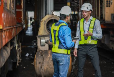 Yazılım mühendisleri, lokomotif işlemleri için akıllı enerji analizi uygulamasını geliştirmenin yollarını tartışıyor. Gerçek zamanlı izleme veri kullanımını optimize eder ve verimli tüketim içgörülerini analiz eder.