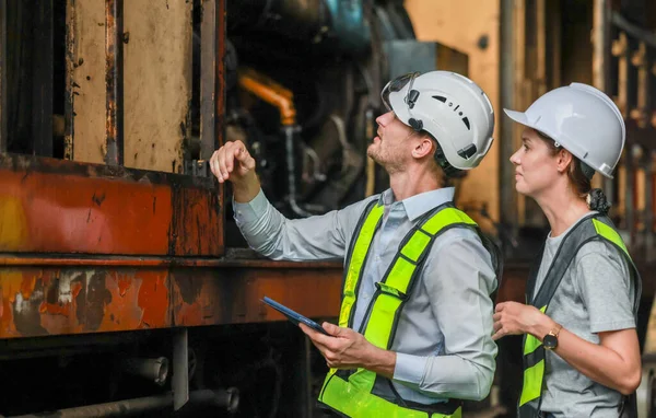 Software engineers collaborate, discuss ways to enhance a smart energy analytics app for locomotive operation. Real-time monitoring optimizes data usage and analyzes efficient consumption insights.