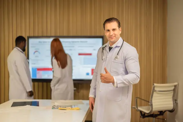 Team of doctors discuss healthcare big data to analyze patient satisfaction trends, waiting status, turnover rates aiming to identify areas for improvement, create cost effective management plans.