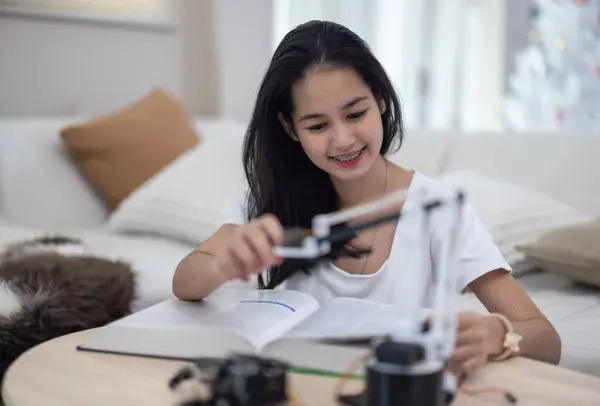 College students engage in active learning and experimental exploration with STEM educational robots at home. Applying textbooks, integrating concepts from engineering, programming, problem-solving.