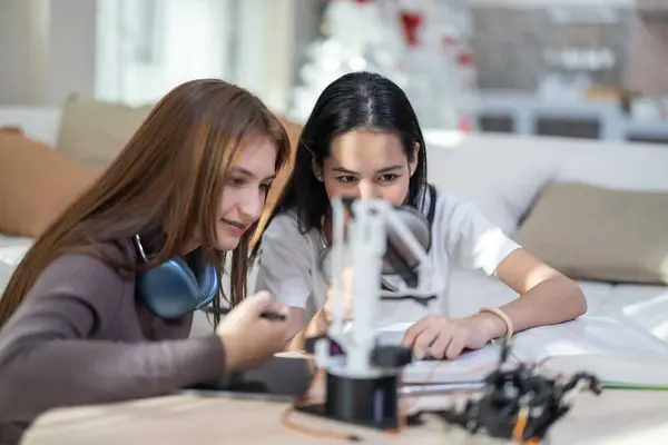 College students engage in active learning and experimental exploration with STEM educational robots at home. Applying textbooks, integrating concepts from engineering, programming, problem-solving.