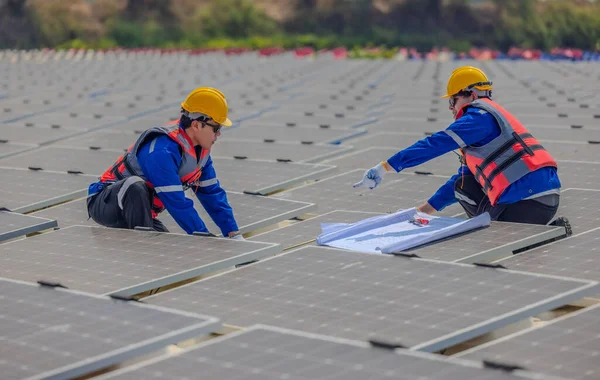 Two Solar Farming Engineers Intently Studying Set Blueprints While Conducting — Stock Photo, Image