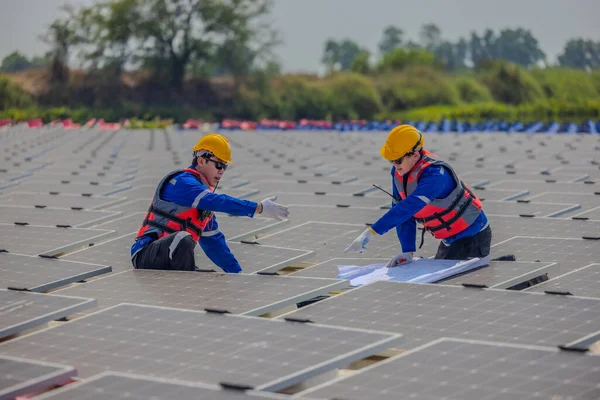 Two Solar Farming Engineers Intently Studying Set Blueprints While Conducting — Stock Photo, Image