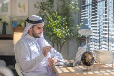 Sheikh, CEO in arb dress, supervising business, distant meetings, and communication via video call with the team with a smile gesture. Overseeing operations as a leader, showcasing responsibilities. clipart
