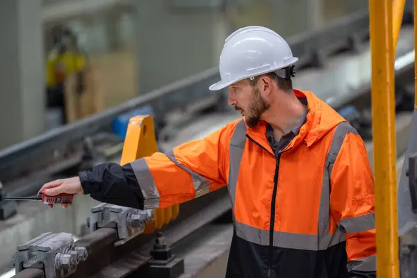Rail maintenance engineer assessing condition of infrastructure. Planning and executing upgrades to rail system that reduce co2 footprint, enhance energy efficiency, focusing on sustainable practices