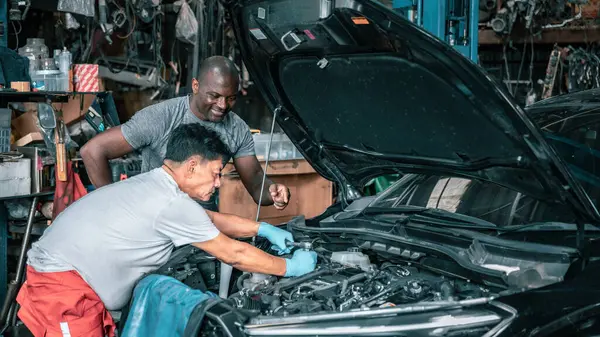 stock image Mechanic carefully repairs a car part in a workshop, showcasing the precision and skill involved in automotive repair. The image emphasizes expertise and dedication in hands on technical work.