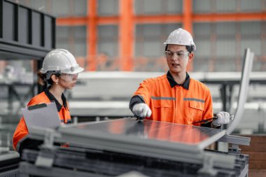 Metal sheet workers at factory plan to install solar panels on roof, promoting renewable energy, reducing costs, registering carbon credits for sustainable and efficient way to combat climate change. clipart