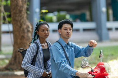 Two young professionals commute together on an electric motorcycle, promoting sustainable and eco friendly travel in an urban setting. The image highlights modern transportation and teamwork. clipart