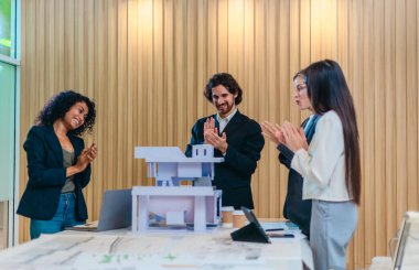 Mimarlar ve tasarımcılar, sürdürülebilir tasarım unsurları ve 3D mimari modeli hakkında görüşmek üzere çevre dostu bir bina projesinde işbirliği yaparlar. Karbon ayak izini azaltmak için enerji tasarruflu çözümler planlanıyor