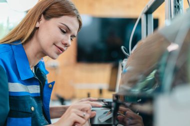 Mühendis, ileri üretim ve prototip teknolojisi sergileyen bir atölyede yeni basılmış üç boyutlu bileşenleri inceliyor. Yenilikleri yansıtan, hassas mühendislik, endüstriyel tasarım süreçleri