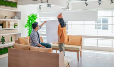 İki profesyonel, parlak ve modern bir çalışma alanında büyük bir planlama tablosunu gözden geçiriyorlar. Sahne, bir başlangıç ortamında takım çalışması, stratejik düşünme ve işbirlikçi proje gelişimini yansıtıyor