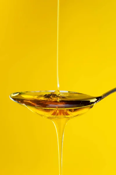 stock image honey drizzling onto a spoon 