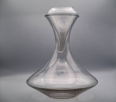glass decanter on a white background, useful for decanting and oxygenating wine, in this case excellent Italian wine