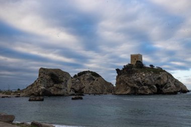 Gökyüzünde büyük bulutlar olan uzak dağ kayaları