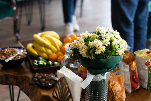 Shot of snacks table with flowers and fruits