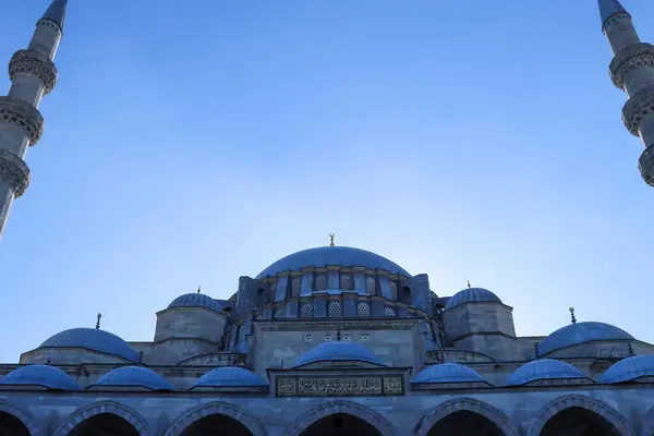 low angle shot of mosque exterior with a clear blue sky