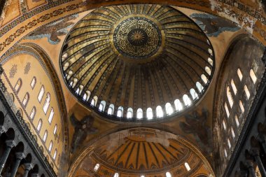 roof of Hagia Sophia with light peeking through windows and ancient paintings on the walls from a different angle