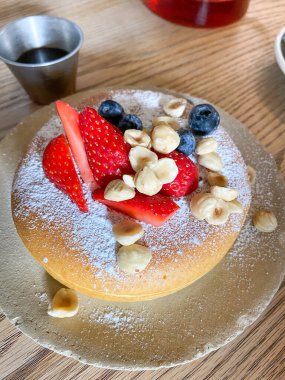 Bir kafede servis edilen çilek, fındık ve yaban mersinli Japon usulü krepler.