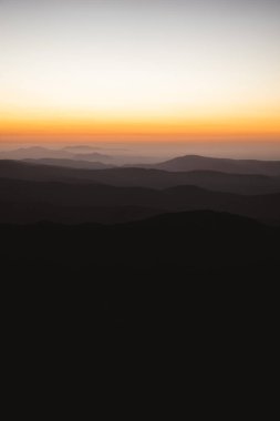 Vertical view of beautiful layers of mountains with golden light after sunset in Las Villuercas, Caceres, Extremadura, Spain