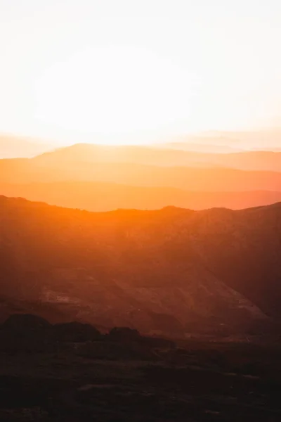 Vertical view of beautiful layers of mountains with golden light at sunset in Las Villuercas, Caceres, Extremadura, Spain