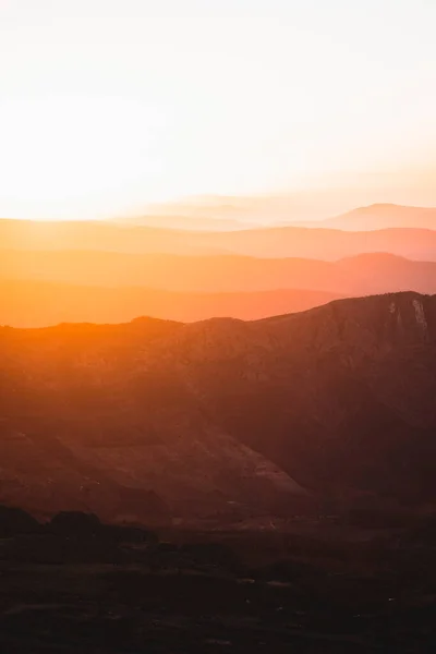 Vertical view of beautiful layers of mountains with golden light at sunset in Las Villuercas, Caceres, Extremadura, Spain