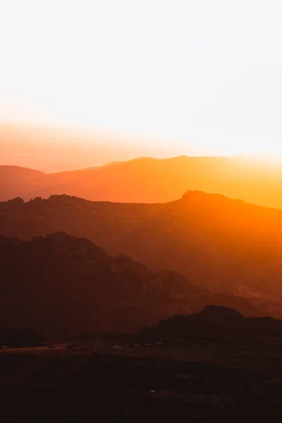 Vertical view of beautiful layers of mountains with golden light at sunset in Las Villuercas, Caceres, Extremadura, Spain