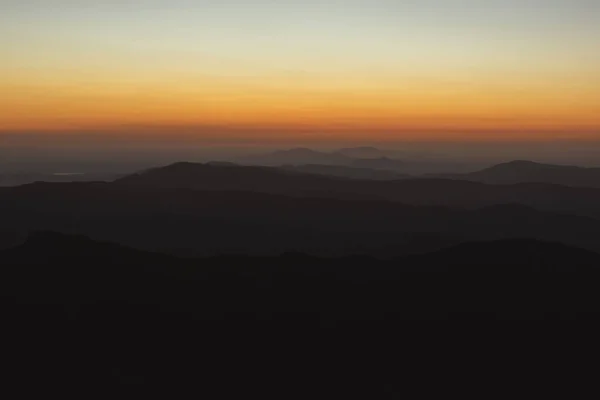 Horizontal view of beautiful layers of mountains with golden light after sunset in Las Villuercas, Caceres, Extremadura, Spain