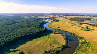 Nehrin yukarısındaki İHA 'dan hava görüntüsü. Bulutlu yeşil çimen ve gökyüzü.