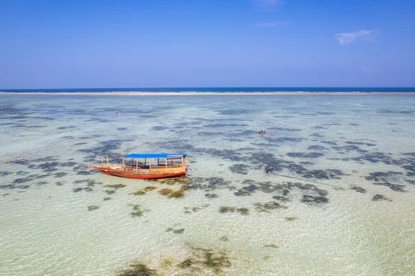 Catamaran (Ngalawa) on amazing turquoise water in the Indian ocean next to Mnemba atoll, Zanzibar, Tanzania