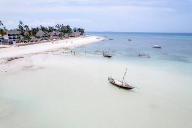 Sailing with a sail boat in Kenya, Zanzibar and in beautiful crystal Turquoise water on white sand tropical beach. Traditional fishing wooden boat in Diani Beach, Watamu and Zanzibar