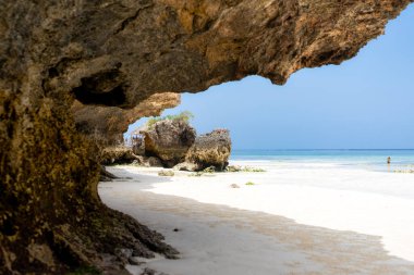 Landscape of the Indian Ocean coastline with at Mtende Beach, Zanzibar. Rocks and white sand. View from the sea