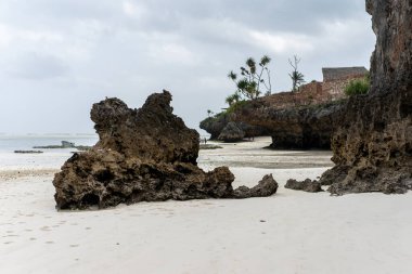 Sunny vacation at Mtende Beach, Zanzibar, surrounded by rocks for a peaceful retreat