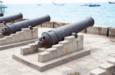 Cannons in Stone Town, Zanzibar, are a reminder of its dark history of slavery. These relics serve as a somber reminder of the island's past.
