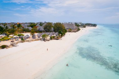 This drone shot of Nungwi Beach in Zanzibar captures the incredible beauty of the shoreline, with crystal-clear waters and golden sand providing a picture-perfect view.