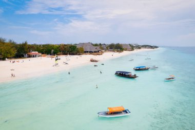 This drone shot of Nungwi Beach in Zanzibar captures the incredible beauty of the shoreline, with crystal-clear waters and golden sand providing a picture-perfect view.