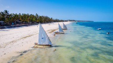 The traditional dhows on Zanzibar's beaches are a symbol of the island's connection to the sea and its fishing traditions. clipart