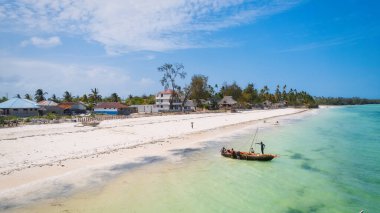 Embark on a journey to the paradise lagoons of Zanzibar, where palm trees and blue ocean meet for a truly breathtaking view.