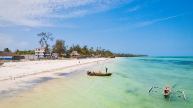 Embark on a journey to the paradise lagoons of Zanzibar, where palm trees and blue ocean meet for a truly breathtaking view.