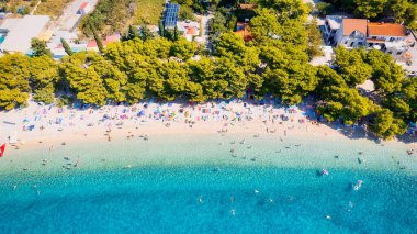 Get lost in the picturesque scene of Croatia's beach, with its stunning turquoise waters and pristine coastline. From above, the aerial view showcases the perfect spot for a vacation and adventure. The drone's-eye view captures the essence of travel