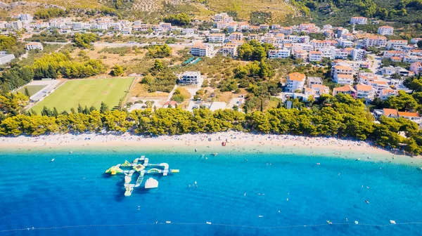 Get lost in the picturesque scene of Croatia's beach, with its stunning turquoise waters and pristine coastline. From above, the aerial view showcases the perfect spot for a vacation and adventure. The drone's-eye view captures the essence of travel
