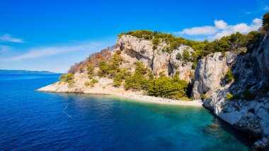 Get lost in the picturesque scene of Croatia's beach, with its stunning turquoise waters and pristine coastline. From above, the aerial view showcases the perfect spot for a vacation and adventure. The drone's-eye view captures the essence of travel