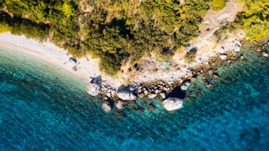 The stunning beauty of Croatia's rocks and forests is captured in this breathtaking aerial view. Take in the turquoise waters and beach from above, and add this travel image to your collection of unforgettable memories.