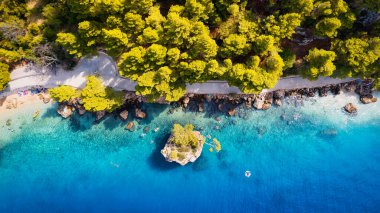 Enjoy the view of Croatia's beach from above, where turquoise waters meet soft sands. Relax and find adventure in this beautiful vacation spot, captured in stunning aerial photography.