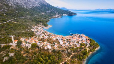 Enjoy the view of Croatia's beach from above, where turquoise waters meet soft sands. Relax and find adventure in this beautiful vacation spot, captured in stunning aerial photography.
