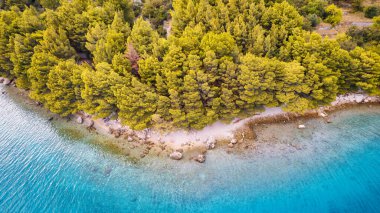 The stunning beauty of Croatia's rocks and forests is captured in this breathtaking aerial view. Take in the turquoise waters and beach from above, and add this travel image to your collection of unforgettable memories.