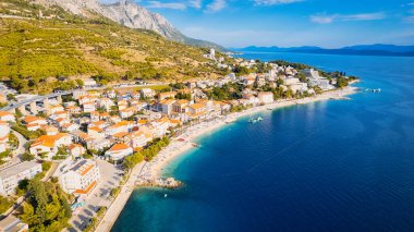 Enjoy the view of Croatia's beach from above, where turquoise waters meet soft sands. Relax and find adventure in this beautiful vacation spot, captured in stunning aerial photography.